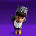 A toddler wearing GriBOO the grey dragon plush onesie with a dragon-like hood, photographed against a solid purple studio background.